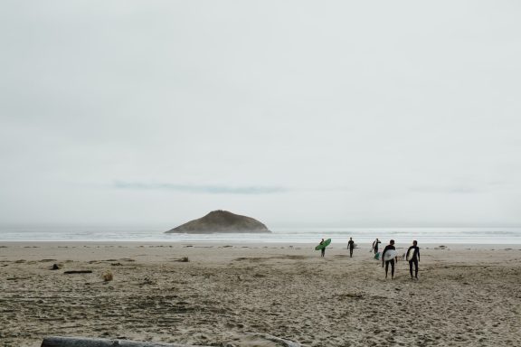 Group of friends headed out to catch some winter swell at the famous Long Beach in the Pacific Rim National Park nearby to Ucluelet, BC.